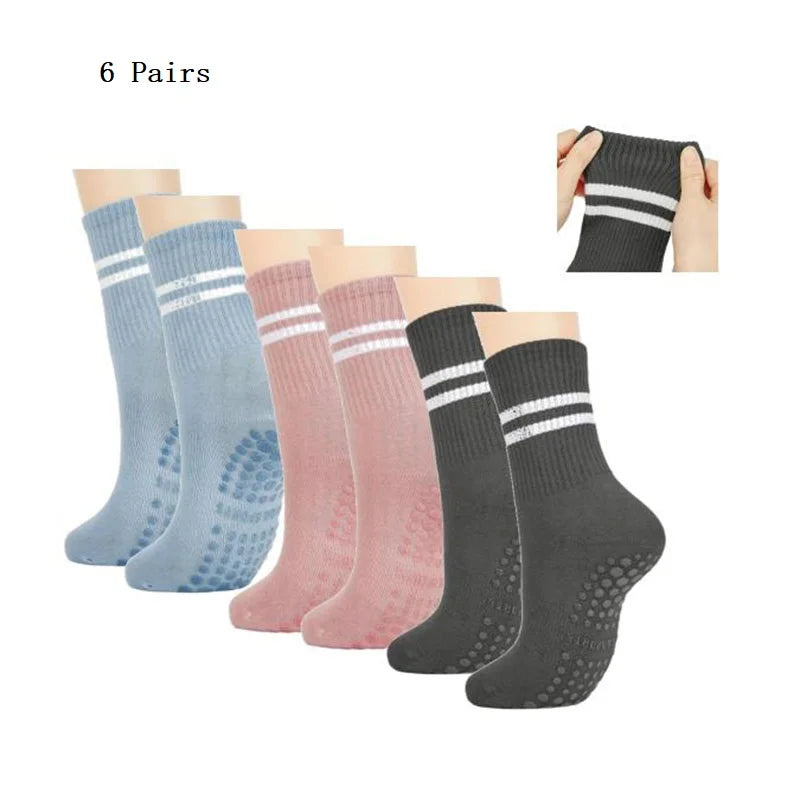 Six pairs of black, gray, and pink grip socks for yoga and barre