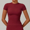 A model wearing a maroon women's breathable yoga and fitness t-shirt.