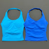 A pair of seamless performance yoga and gym tank tops in bright cyan and royal blue.