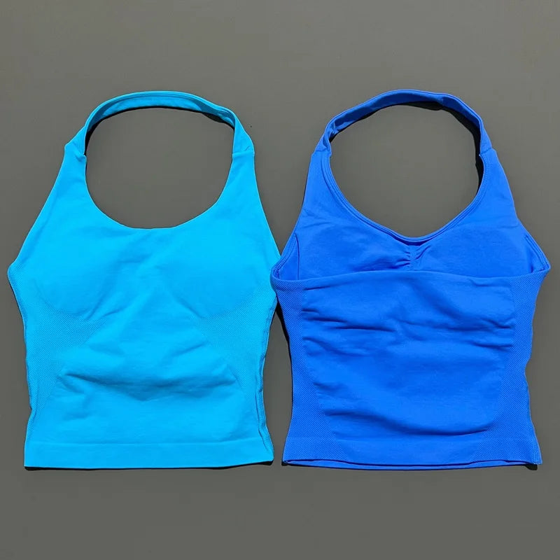 A pair of seamless performance yoga and gym tank tops in bright cyan and royal blue.