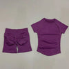 A purple seamless yoga set for women featuring a short sleeve top and workout leggings.