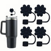 Black silicone straw covers for tumblers and water bottles shown next to a stainless steel tumbler.