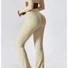 A woman models a beige women's performance tracksuit set featuring a cropped top and high-waisted pants.