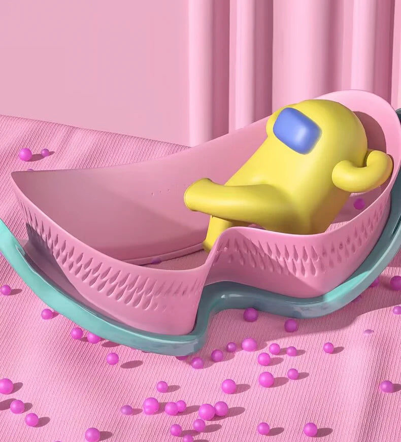 A yellow swimming goggle for a child rests in a pink plastic container on a pink fabric.
