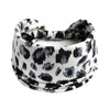 A black and white leopard print cotton stretch headband tied around the head.