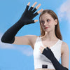 A woman models black compression gloves on her hand against a light blue sky background.