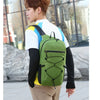 A person wearing a green hiking backpack and white shirt is shown outdoors.