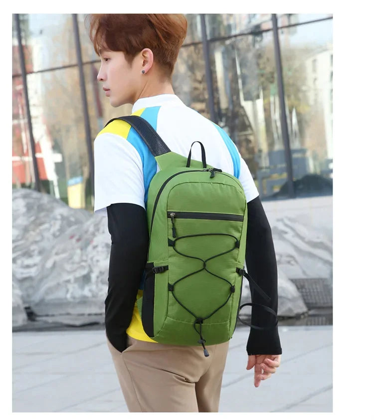 A person wearing a green hiking backpack and white shirt is shown outdoors.