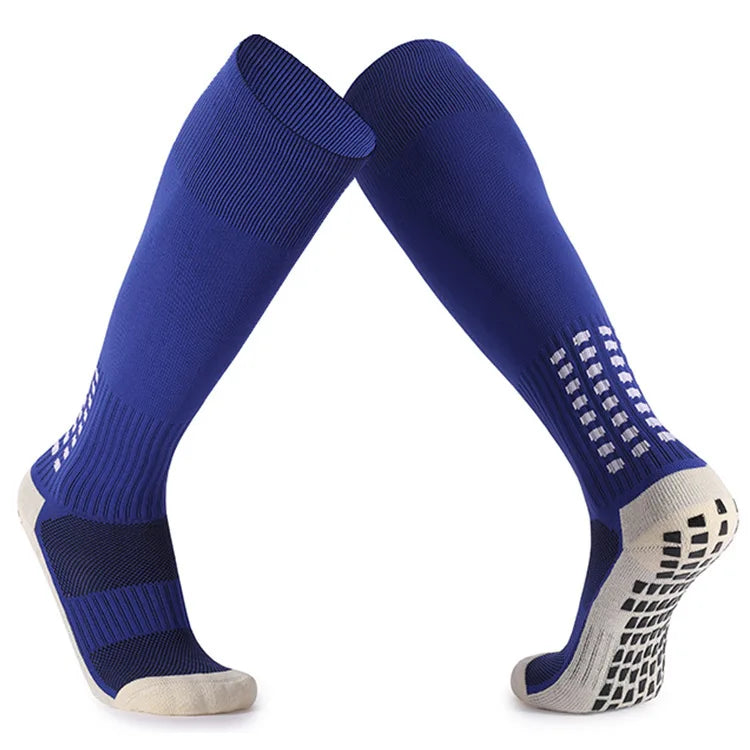 A pair of navy blue long football training socks with a light gray cuff and patterned toe area.