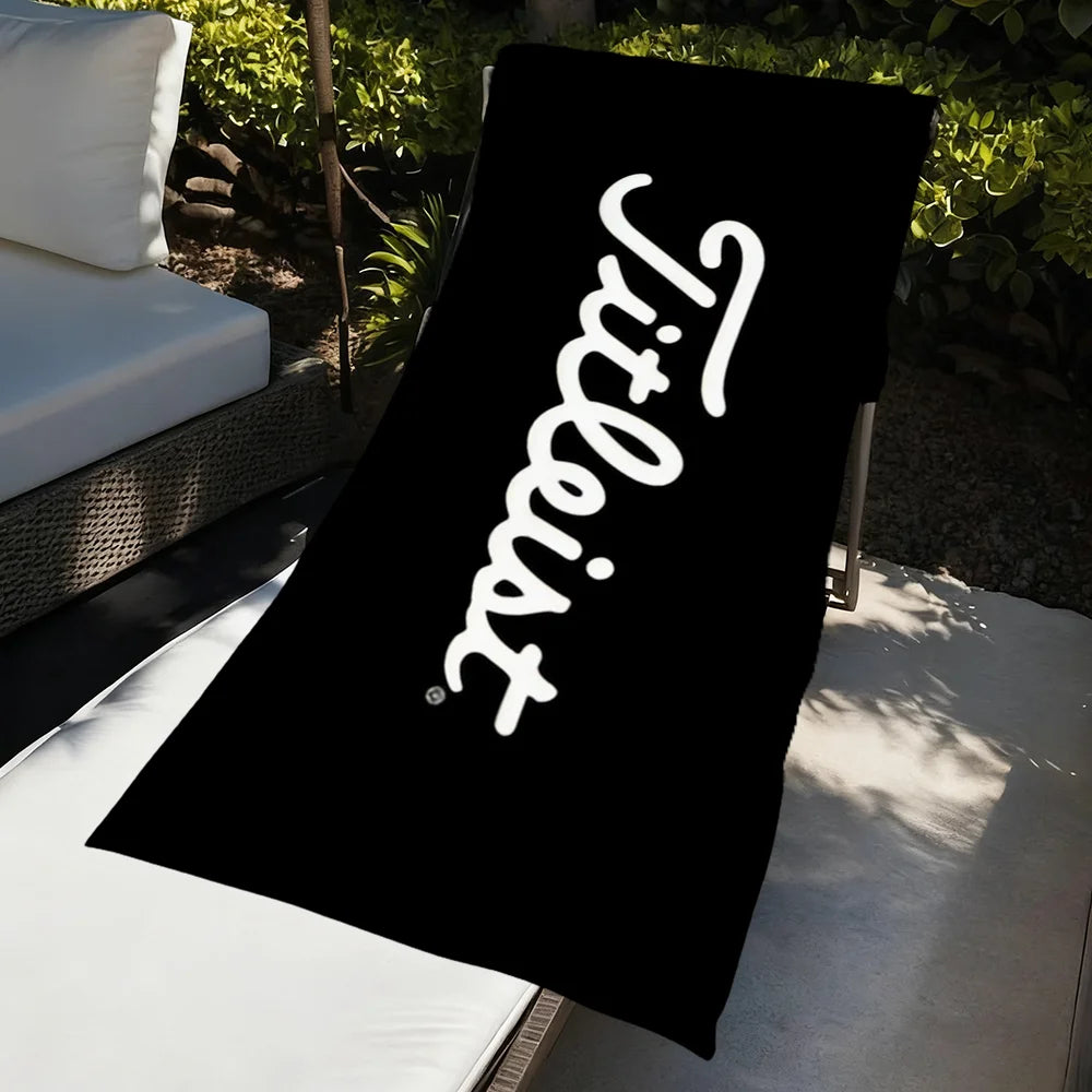 A black towel with white text reading 'Tiltless' is displayed on a white surface.