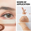 Close-up of an eye showing eyelash extension tape application on the eyelid and surrounding skin.