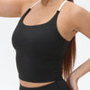 A woman wearing a black women's athletic crisscross tank top with white trim.