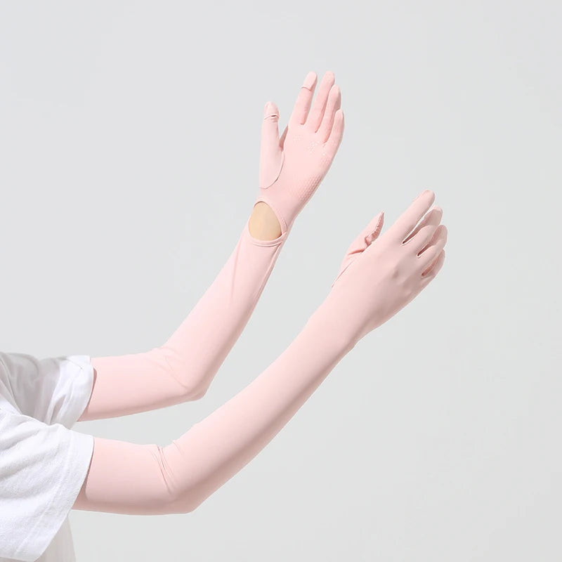 A hand wearing a light pink UPF 50+ sun protection arm sleeve, showing a patch on the forearm.