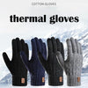 A close-up of several black and navy thermal knit gloves displayed against a snowy mountain background.