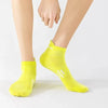 A bright yellow pair of premium breathable men's running socks worn on a person's foot.