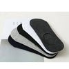 A stack of multi-colored breathable cotton ankle socks in black, gray, and white are displayed on a white surface.