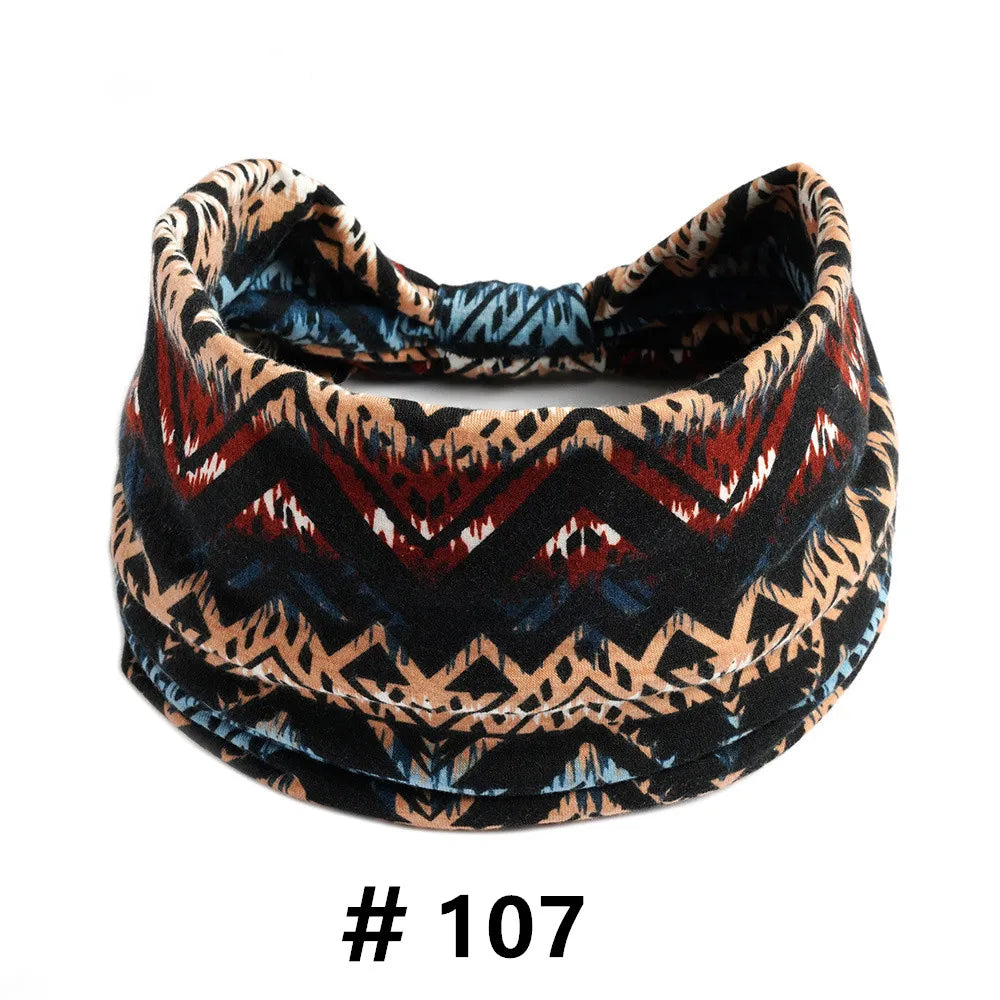 A close-up of a black and brown patterned boho cotton turban headband.