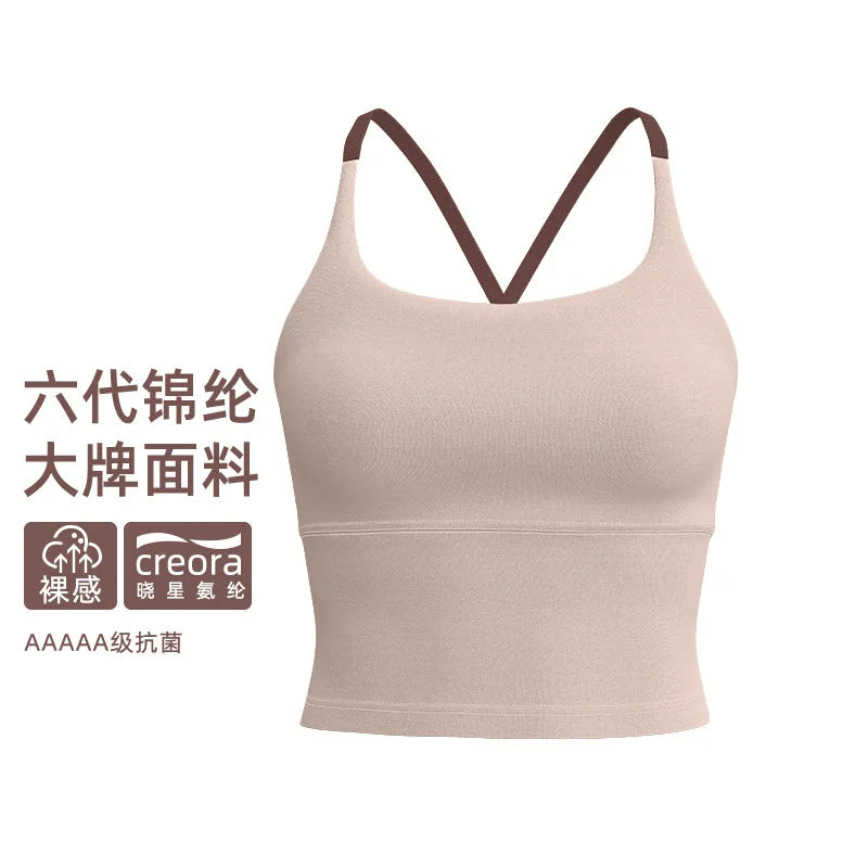 A beige sports bra with thin straps shown against a white background.