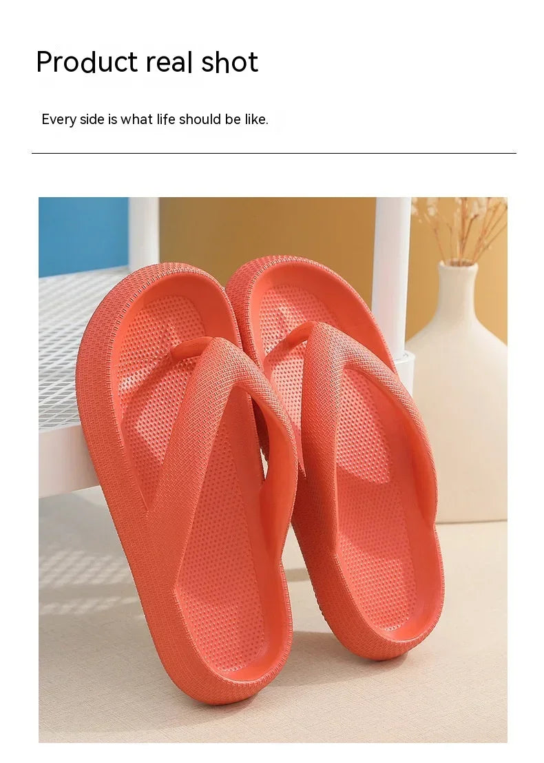 A pair of bright orange comfort platform flip flops shown in a product real shot.