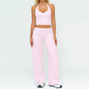 A woman wearing a pink women's premium fitness tracksuit top and matching pants.