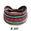 A colorful patterned boho cotton turban headband with a tie, featuring stripes of red, black, and teal.