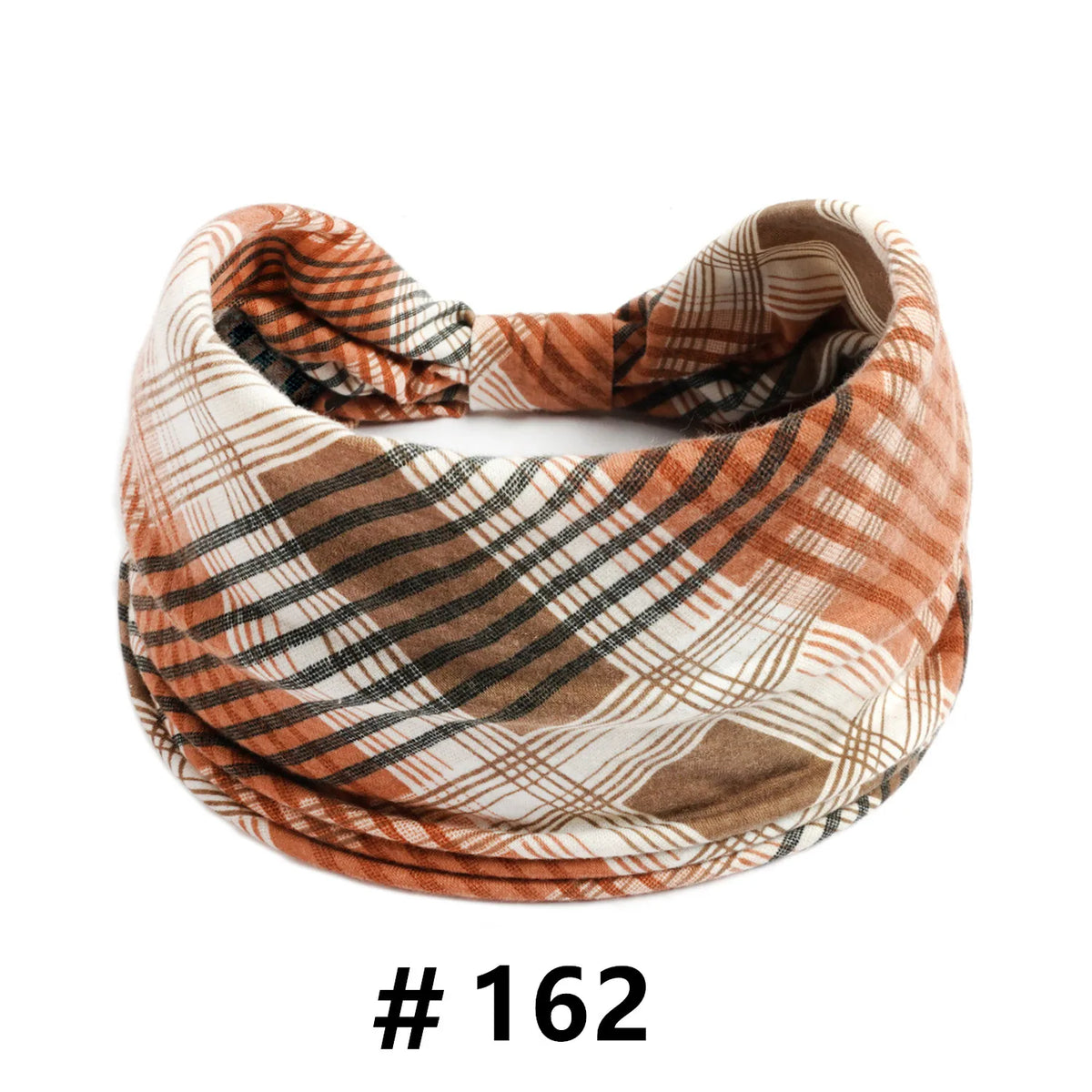 A close-up of a plaid, earthy-toned cotton turban headband for workout or yoga.
