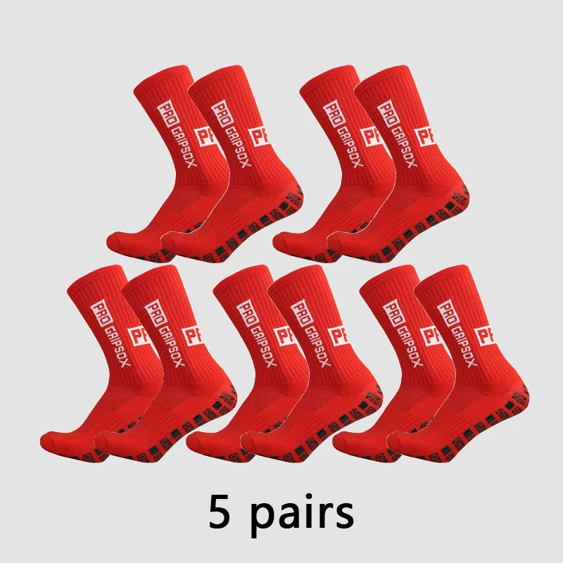 Five pairs of red Pro Grip Sox anti-slip soccer socks laid out on a light gray background.