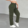 A woman wearing olive green drawstring cargo pants with a black zipper detail.