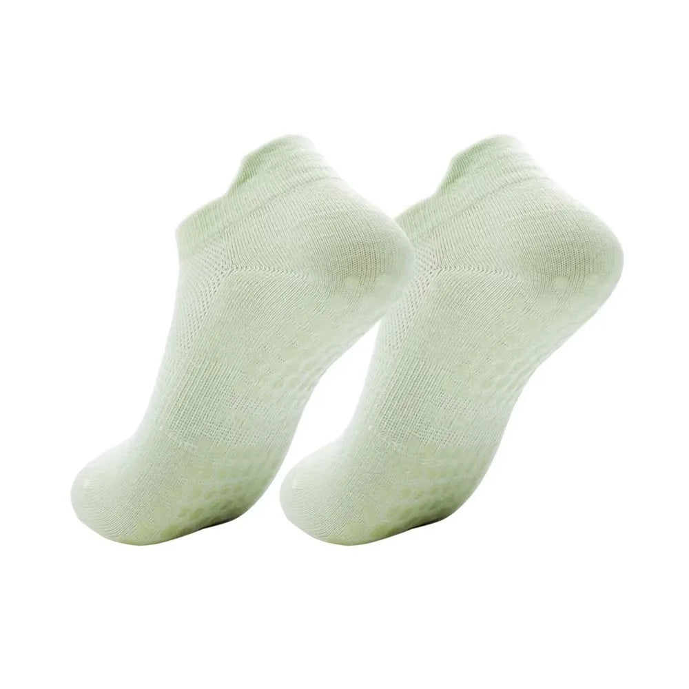 A pair of light green women's yoga and fitness socks shown from the side.