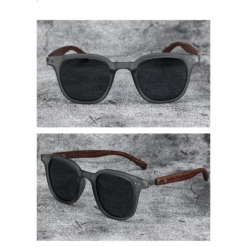 A pair of dark gray sunglasses with brown wood grain frames and lenses set against a gray textured background.