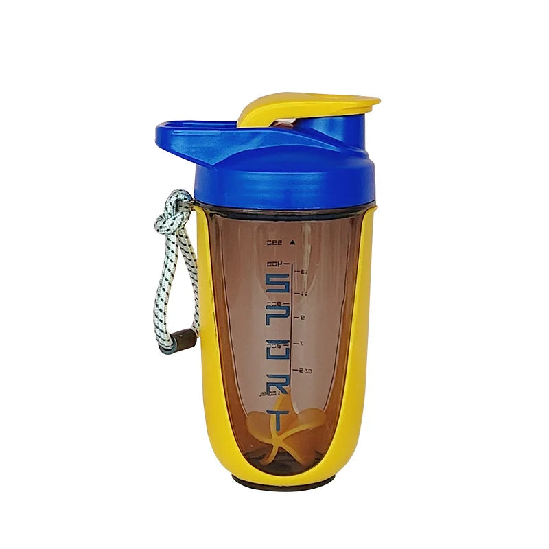 A yellow and blue blender shaker bottle with a mesh strainer attached for sports and gym use.