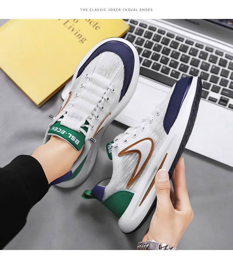 A pair of white and green casual shoes shown on a hand next to a laptop keyboard.