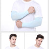 A man wearing white clothing demonstrates light blue cooling arm sleeves for UV protection.