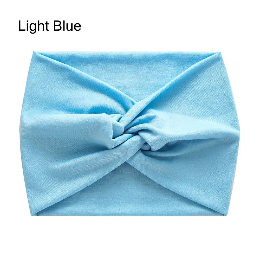 Light blue cross-knotted fabric headband for yoga and workout