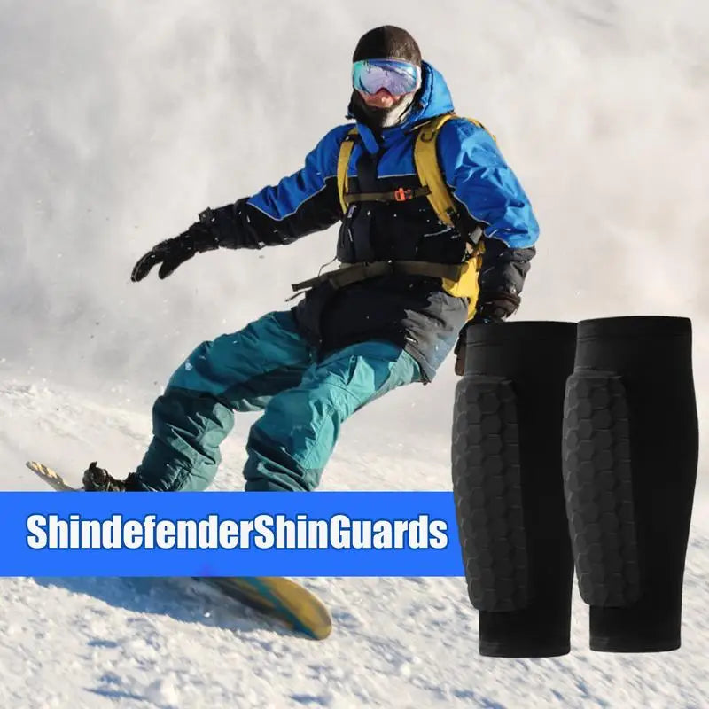A person wearing blue and yellow gear is shown with black leg guards in a snowy outdoor setting.
