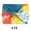 Bandeau en coton tie-dye aux couleurs vives bleu, jaune et orange.