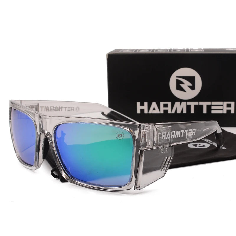 Clear framed polarized sports sunglasses with blue-green lenses displayed next to their packaging box.