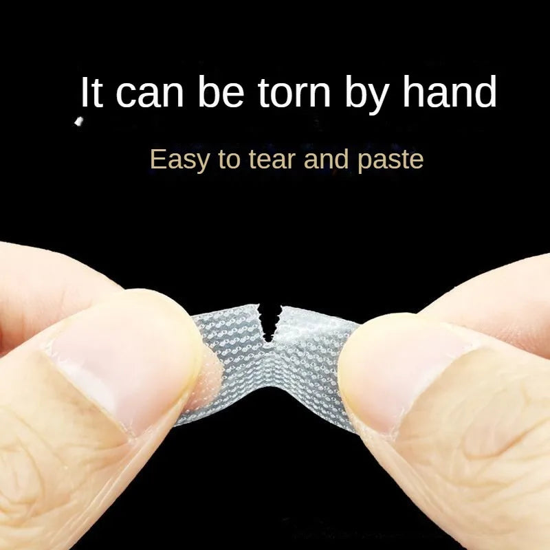 A hand is tearing apart a piece of transparent fabric eyelash extension tape.