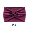 A deep magenta fabric headband tied in a bow shape.