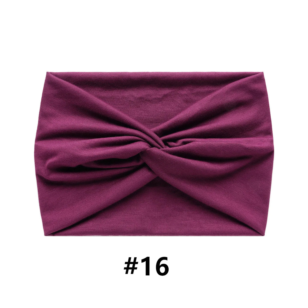 A deep magenta fabric headband tied in a bow shape.