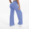 A person is modeling light blue high-waist yoga pants with white sneakers.