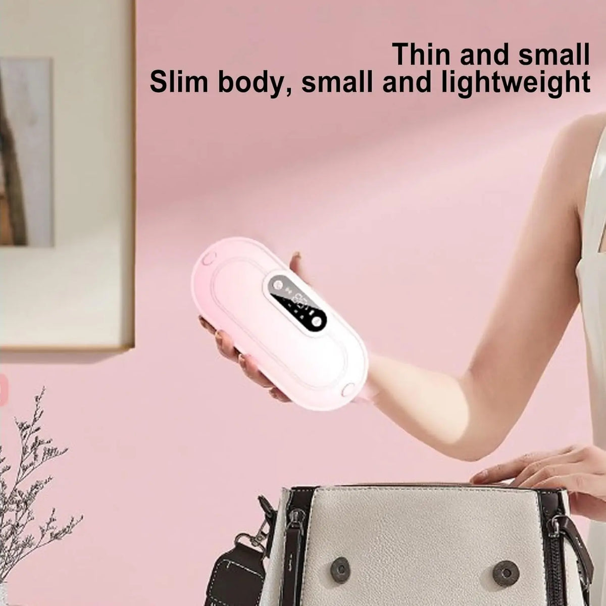 A hand holds a pink portable menstrual heating pad against a pink background.