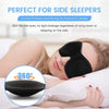A woman is sleeping with a black memory foam sleep mask on her eyes, demonstrating its use for side sleepers.