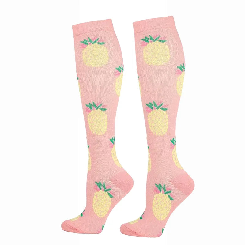Pair of pink compression elastic socks with a yellow fruit pattern