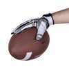 Une main portant des gants de sport en silicone anti-dérapants noir et blanc agrippe une balle d'exercice marron.