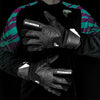 Black latex goalkeeper gloves with a wrist strap worn on a person's hand.