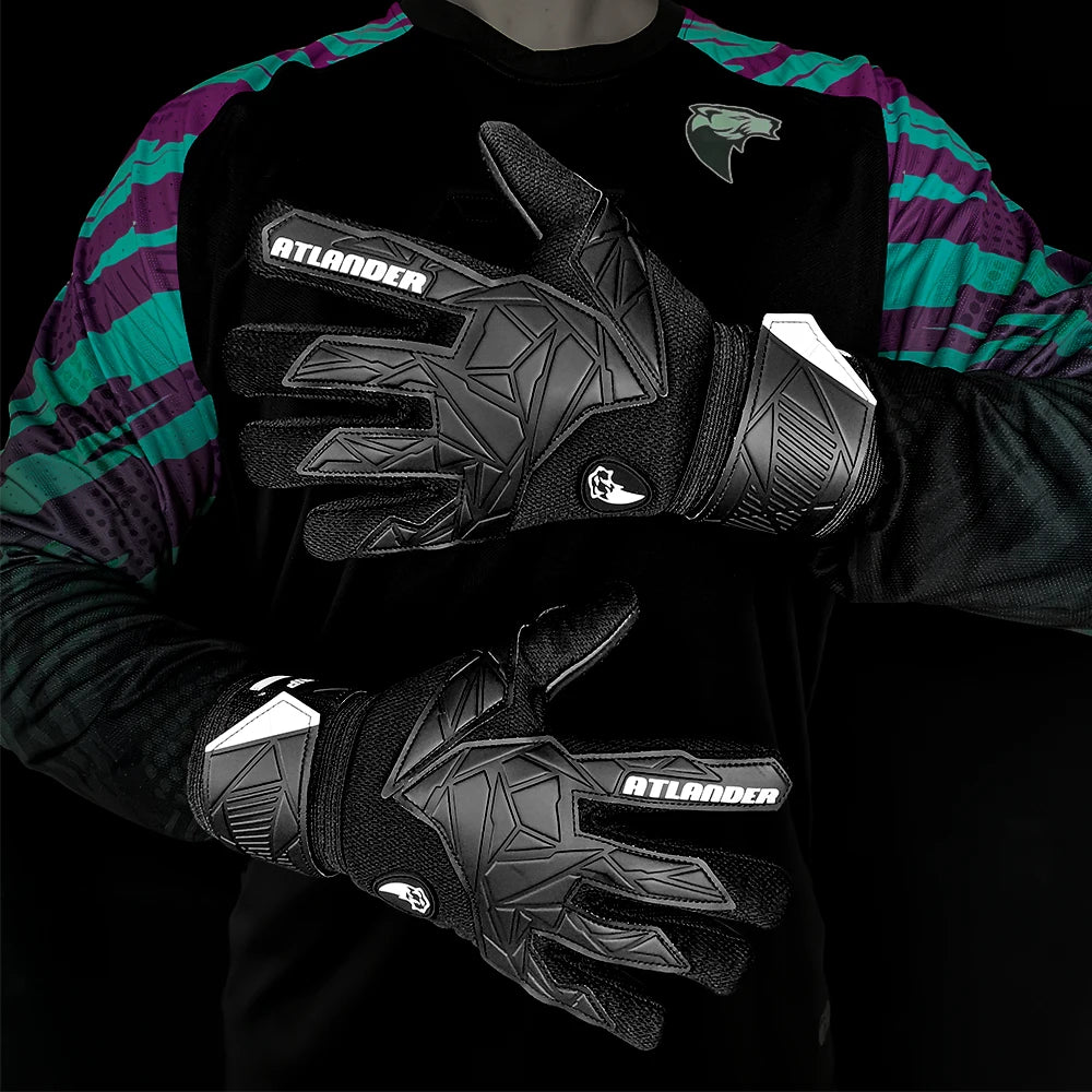 Black latex goalkeeper gloves with a wrist strap worn on a person's hand.