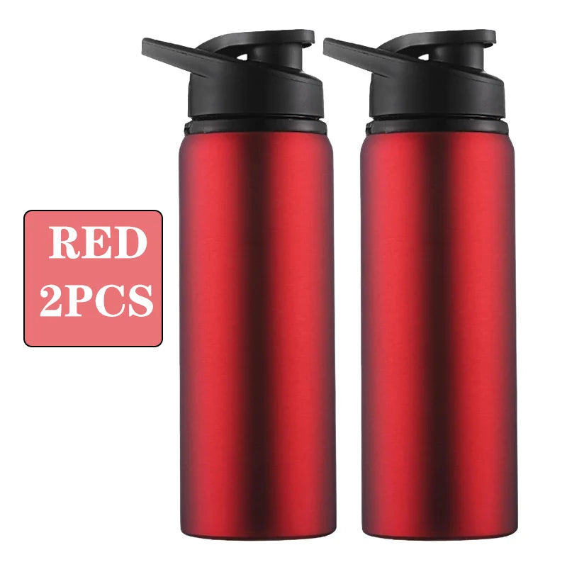 Two red leakproof portable aluminum water bottles with black caps