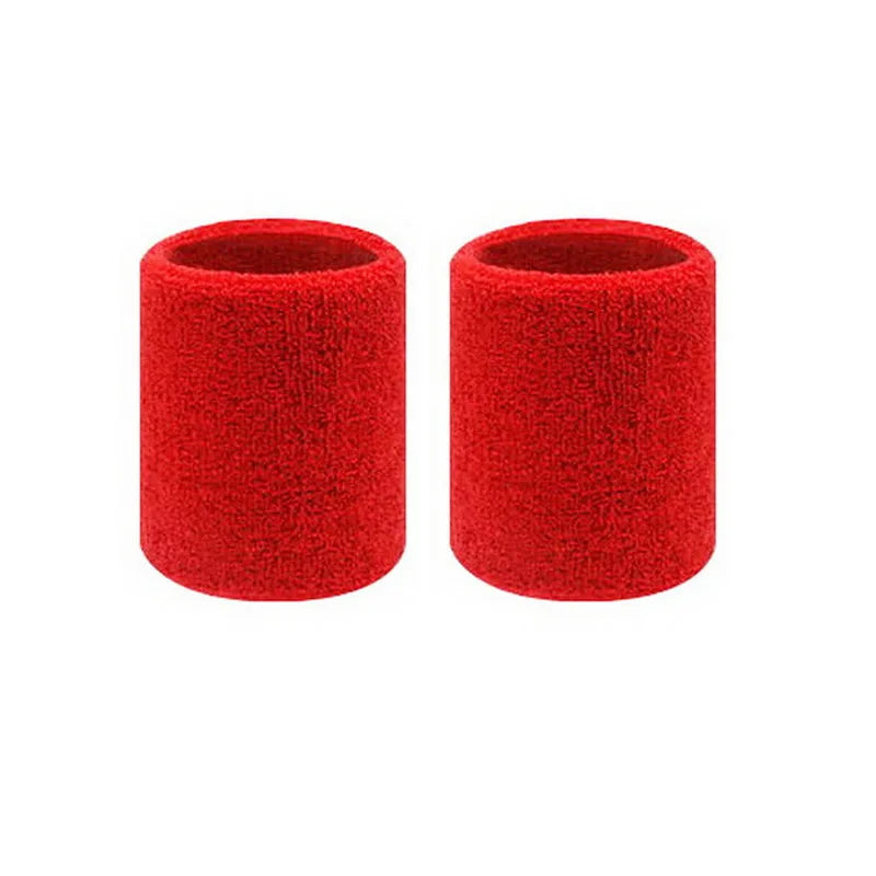 A pair of red dual sports wristbands designed for sweat absorption.