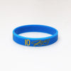 A bright blue silicone wristband with the number 10 and a gold signature on the face.